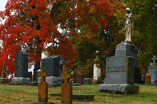 Weathered sculptures set apart the autumn colors in St. Peter Cemetery in Jefferson City.